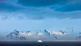 Distant icebergs, mountains, clouds, ocean at dawn, in the South Shetland Islands, near Deception Island. Antarctic Peninsula, Antarctica. Image #25460