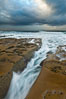 Waves wash over sandstone reef, clouds and sky. La Jolla, California, USA. Image #26338