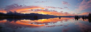 Sun pillar rises over the Sierra Nevada and this Mono Lake sunset, Sierra Nevada mountain range and tufas, clouds reflected in the still waters of Mono Lake. California, USA. Image #26968