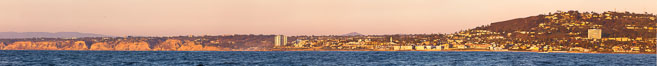 Panorama of La Jolla, with Mount Soledad aglow at sunset, viewed from the Pacific Ocean offshore of San Diego. California, USA. Image #27085