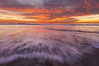 Sunset and incoming surf, gorgeous colors in the sky and on the ocean at dusk, the incoming waves are blurred in this long exposure. Carlsbad, California, USA. Image #27157