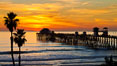 Oceanside Pier at sunset, clouds and palm trees with a brilliant sky at dusk. California, USA. Image #27612