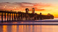 Oceanside Pier at sunset, clouds with a brilliant sky at dusk, the lights on the pier are lit. California, USA. Image #27614