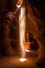 Light Beam in Upper Antelope Slot Canyon.  Thin shafts of light briefly penetrate the convoluted narrows of Upper Antelope Slot Canyon, sending piercing beams through the sandstone maze to the sand floor below. Navajo Tribal Lands, Page, Arizona, USA. Image #28566