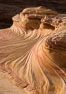 The Second Wave at sunset. The Second Wave, a curiously-shaped sandstone swirl, takes on rich warm tones and dramatic shadowed textures at sunset. Set in the North Coyote Buttes of Arizona and Utah, the Second Wave is characterized by striations revealing layers of sedimentary deposits, a visible historical record depicting eons of submarine geology. Paria Canyon-Vermilion Cliffs Wilderness, USA. Image #28613