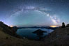 Milky Way and stars over Crater Lake at night. Panorama of Crater Lake and Wizard Island at night, Crater Lake National Park. Oregon, USA. Image #28640