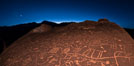 Sunset and stars over Sky Rock.  Sky Rock petroglyphs near Bishop, California. Hidden atop an enormous boulder in the Volcanic Tablelands lies Sky Rock, a set of petroglyphs that face the sky. These superb examples of native American petroglyph artwork are thought to be Paiute in origin, but little is known about them. USA