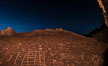 Sunset and stars over Sky Rock.  Sky Rock petroglyphs near Bishop, California. Hidden atop an enormous boulder in the Volcanic Tablelands lies Sky Rock, a set of petroglyphs that face the sky. These superb examples of native American petroglyph artwork are thought to be Paiute in origin, but little is known about them. USA. Image #28803