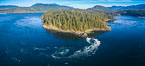 Seymour Narrows with strong tidal currents.  Between Vancouver Island and Quadra Island, Seymour Narrows is about 750 meters wide and has currents reaching 15 knots.  Aerial photo. British Columbia, Canada. Image #34491