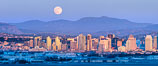 Full Moon Rises over San Diego City Skyline, viewed from Point Loma, panoramic photograph. The mountains east of San Diego can be clearly seen when the air is cold, dry and clear as it is in this photo.  Mount Laguna is the peak rising in the distance. California, USA. Image #37501