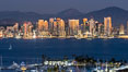 San Diego City Skyline at Sunset, viewed from Point Loma, panoramic photograph. The mountains east of San Diego can be clearly seen when the air is cold, dry and clear as it is in this photo. Lyons Peak is in center and Mount San Miguel to the right. California, USA. Image #37504