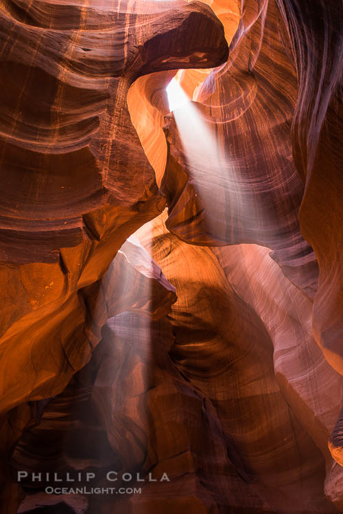 Light Beam in Upper Antelope Slot Canyon.  Thin shafts of light briefly penetrate the convoluted narrows of Upper Antelope Slot Canyon, sending piercing beams through the sandstone maze to the sand floor below.