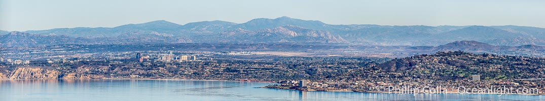 Aerial Panorama of La Jolla, University City, showing (from left) University of California at San Diego, University City, Scripps Institution of Oceanography, La Jolla Shores, Point La Jolla, Mount Soledad, in the background some of the mountains to the east of San Diego.  The highest peak in the center of the panoram is Cuyamaca Peak (6512') while the rocky peak directly in front of it is El Cajon Mountain (3675')