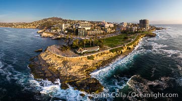 Aerial Panoramic Photo of Point La Jolla at sunset, La Jolla and Mount Soledad. People enjoying the sunset on the sea wall looking at sea lions on the rocks