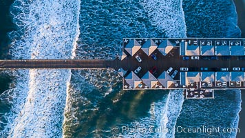 Aerial Photo of Crystal Pier, 872 feet long and built in 1925, extends out into the Pacific Ocean from the town of Pacific Beach, San Diego, California