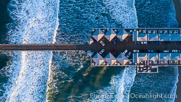 Aerial Photo of Crystal Pier, 872 feet long and built in 1925, extends out into the Pacific Ocean from the town of Pacific Beach, San Diego, California