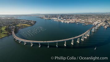 Aerial Photo of San Diego Coronado Bridge, known locally as the Coronado Bridge, links San Diego with Coronado, California. The bridge was completed in 1969 and was a toll bridge until 2002. It is 2.1 miles long and reaches a height of 200 feet above San Diego Bay. Coronado Island is to the left, and downtown San Diego is to the right in this view looking north