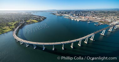 Aerial Photo of San Diego Coronado Bridge, known locally as the Coronado Bridge, links San Diego with Coronado, California. The bridge was completed in 1969 and was a toll bridge until 2002. It is 2.1 miles long and reaches a height of 200 feet above San Diego Bay. Coronado Island is to the left, and downtown San Diego is to the right in this view looking north