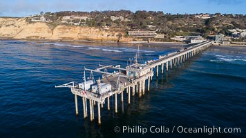 Aerial Photo of Scripps Pier. SIO Pier. The Scripps Institution of Oceanography research pier is 1090 feet long and was built of reinforced concrete in 1988, replacing the original wooden pier built in 1915. The Scripps Pier is home to a variety of sensing equipment above and below water that collects various oceanographic data. The Scripps research diving facility is located at the foot of the pier. Fresh seawater is pumped from the pier to the many tanks and facilities of SIO, including the Birch Aquarium. The Scripps Pier is named in honor of Ellen Browning Scripps, the most significant donor and benefactor of the Institution