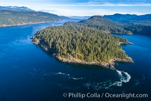 Seymour Narrows with strong tidal currents.  Between Vancouver Island and Quadra Island, Seymour Narrows is about 750 meters wide and has currents reaching 15 knots.  Aerial photo