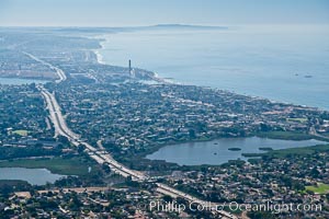 Aerial view of coastal Carlsbad and Oceanside, looking south.  The I-5 freeway and Buena Vista Lagoon are seen in the center of the photo