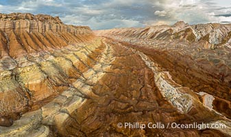 Aerial View of the San Rafael Reef, Utah.  This is a canyon-like section of the San Rafael Reef, photographed at sunrise. The "reef proper" is on the right, with its characteristic triangular flatiron erosion. The canyon in the center is a fold in the Earth's crust affiliated with the boundary of the San Rafael Swell.  The colors seen here arise primarily from Navajo and Wingate sandstone