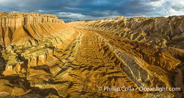 Aerial View of the San Rafael Reef, Utah.  This is a canyon-like section of the San Rafael Reef, photographed at sunrise. The "reef proper" is on the right, with its characteristic triangular flatiron erosion. The canyon in the center is a fold in the Earth's crust affiliated with the boundary of the San Rafael Swell.  The colors seen here arise primarily from Navajo and Wingate sandstone