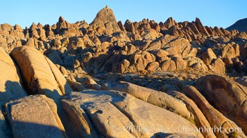 The Alabama Hills, with characteristic curious eroded rock formations formed of ancient granite and metamorphosed rock, next to the Sierra Nevada mountains and the town of Lone Pine, Alabama Hills Recreational Area