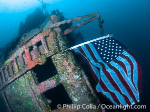 American Flag Flying Over The Wreck of the HMCS Yukon in San Diego.  Deliberately sunk in 2000 as part of San Diego's Wreck Alley to form an artifical reef, the HMCS Yukon is a 366-foot-long former Canadian destroyer.  It is encrusted with a variety of invertebrate life, including Cornyactis anemones which provide much of the color seen here