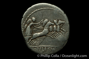 Ancient Roman coin, minted by Julius Brusio (85 B.C.), (silver, denom/type: Denarius) (Denarius Juilius Brusio. Bust of genius right, Laur. and winged, trident and symbol behind. Reverse: Victory in quadriga r. L.IVLI.BVRSIO in ex. BMC. 2485.)