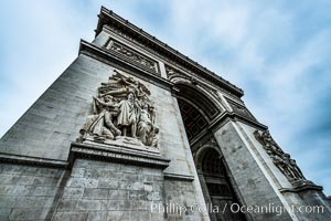 Arc de Triomphe. The Arc de Triomphe (Arc de Triomphe de l'Etoile) is one of the most famous monuments in Paris. It stands in the centre of the Place Charles de Gaulle (originally named Place de l'Etoile), at the western end of the Champs-Elysees. The Arc de Triomphe (in English: "Triumphal Arch") honors those who fought and died for France in the French Revolutionary and the Napoleonic Wars, with the names of all French victories and generals inscribed on its inner and outer surfaces. Beneath its vault lies the Tomb of the Unknown Soldier from World War I. The monument was designed by Jean Chalgrin in 1806, and its iconographic program pitted heroically nude French youths against bearded Germanic warriors in chain mail. It set the tone for public monuments, with triumphant patriotic messages. The monument stands 50 metres (164 ft) in height, 45 m (148 ft) wide and 22 m (72 ft) deep