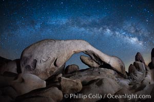 The Milky Way galaxy above Arch Rock, Joshua Tree National Park, night star field exposure
