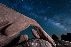 The Milky Way galaxy above Arch Rock, Joshua Tree National Park, night star field exposure.
