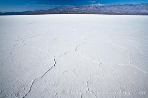 Badwater, California.  Badwater, at 282 feet below sea level, is the lowest point in North America.  9000 square miles of watershed drain into the Badwater basin, to dry and form huge white salt flats. Death Valley National Park, USA, natural history stock photograph, photo id 15579