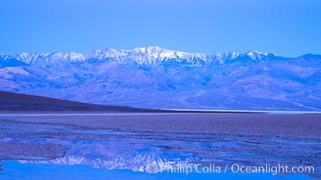 Sunrise lights Telescope Peak as it rises over the salt flats of Badwater, Death Valley.  At 11,049 feet, Telescope Peak is the highest peak in the Panamint Range as well as the highest point in Death Valley National Park.  At 282 feet below sea level, Badwater is the lowest point in North America.