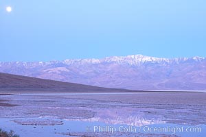 Sunrise lights Telescope Peak as it rises over the salt flats of Badwater, Death Valley.  At 11,049 feet, Telescope Peak is the highest peak in the Panamint Range as well as the highest point in Death Valley National Park.  At 282 feet below sea level, Badwater is the lowest point in North America