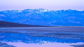 Sunrise lights Telescope Peak as it rises over the salt flats of Badwater, Death Valley.  At 11,049 feet, Telescope Peak is the highest peak in the Panamint Range as well as the highest point in Death Valley National Park.  At 282 feet below sea level, Badwater is the lowest point in North America