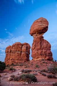 Balanced Rock, a narrow sandstone tower, appears poised to topple, Arches National Park, Utah