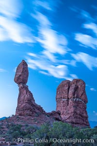 Balanced Rock, a narrow sandstone tower, appears poised to topple, Arches National Park, Utah