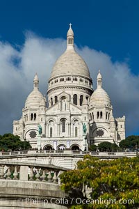 Sacre-Coeur Basilica.  The Basilica of the Sacred Heart of Paris, commonly known as Sacre-Coeur Basilica, is a Roman Catholic church and minor basilica, dedicated to the Sacred Heart of Jesus, in Paris, France. A popular landmark, the basilica is located at the summit of the butte Montmartre, the highest point in the city, Basilique du Sacre-Coeur