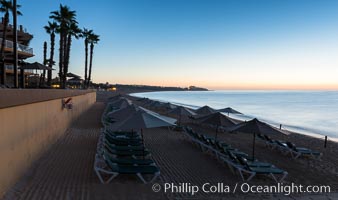 Beach chairs and umbrellas line the sand in front of resorts on Medano Beach, Cabo San Lucas, Mexico