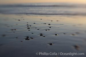 Beach stones and wet sand, reflections of sunset, Ponto, Carlsbad, California
