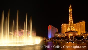 The Bellagio Hotel fountains light up the reflection pool as the half-scale replica of the Eiffel Tower at the Paris Hotel in Las Vegas rises above them, at night