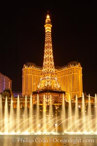 The Bellagio Hotel fountains light up the reflection pool as the half-scale replica of the Eiffel Tower at the Paris Hotel in Las Vegas rises above them, at night