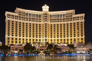 The Bellagio Hotel reflected in the fountain pool at night.  The Bellagio Hotel fountains are one of the most popular attractions in Las Vegas, showing every half hour or so throughout the day, choreographed to famous Hollywood music