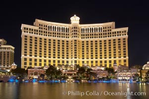 The Bellagio Hotel reflected in the fountain pool at night.  The Bellagio Hotel fountains are one of the most popular attractions in Las Vegas, showing every half hour or so throughout the day, choreographed to famous Hollywood music