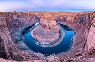 Belt of Venus over Horseshoe Bend on the Colorado River. The Colorado River makes a 180-degree turn at Horseshoe Bend. Here the river has eroded the Navajo sandstone for eons, digging a canyon 1100-feet deep. The Belt of Venus, or anti-twilight arch, is the shadow of the earth cast upon the atmosphere just above the horizon, and occurs a few minutes before sunrise or after sunset, Page, Arizona