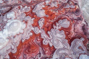 Fantastic colorful sedimentary patterns of Bentonite layers, seen as striations exposed in the Utah Badlands. The Bentonite Hills are composed of the Brushy Basin shale member of the Morrison Formation formed during Jurassic times when mud, silt, fine sand, and volcanic ash were deposited in swamps and lakes into layers, now revealed through erosion. Aerial photograph