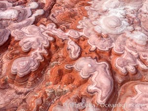 Fantastic colorful sedimentary patterns of Bentonite layers, seen as striations exposed in the Utah Badlands. The Bentonite Hills are composed of the Brushy Basin shale member of the Morrison Formation formed during Jurassic times when mud, silt, fine sand, and volcanic ash were deposited in swamps and lakes into layers, now revealed through erosion. Aerial photograph