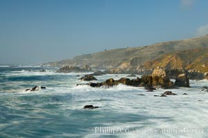 Waves blur as they break over the rocky shoreline of Big Sur